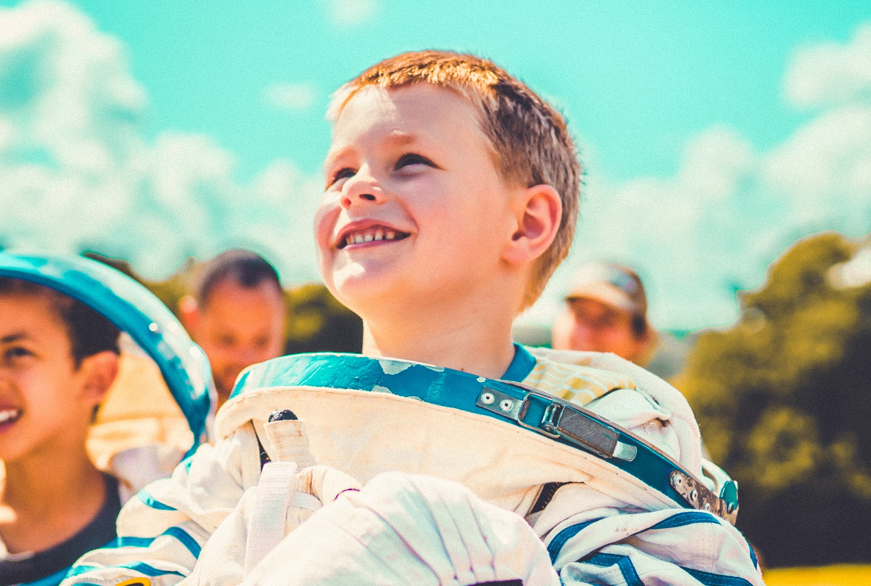 A small boy in an astronaut costume