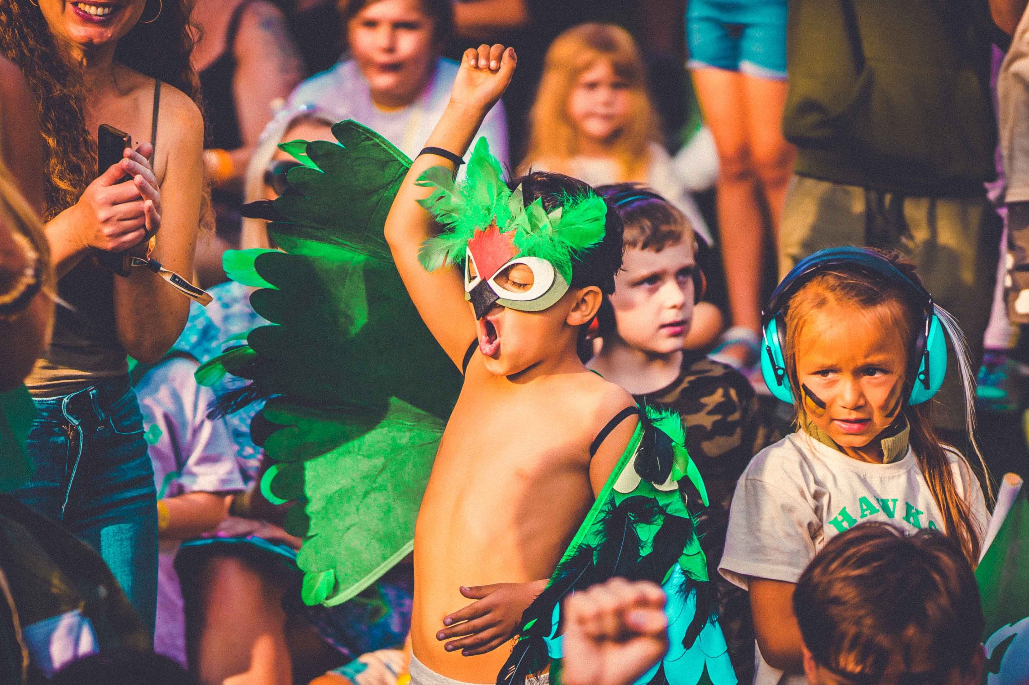Child with a feather mask on wooping