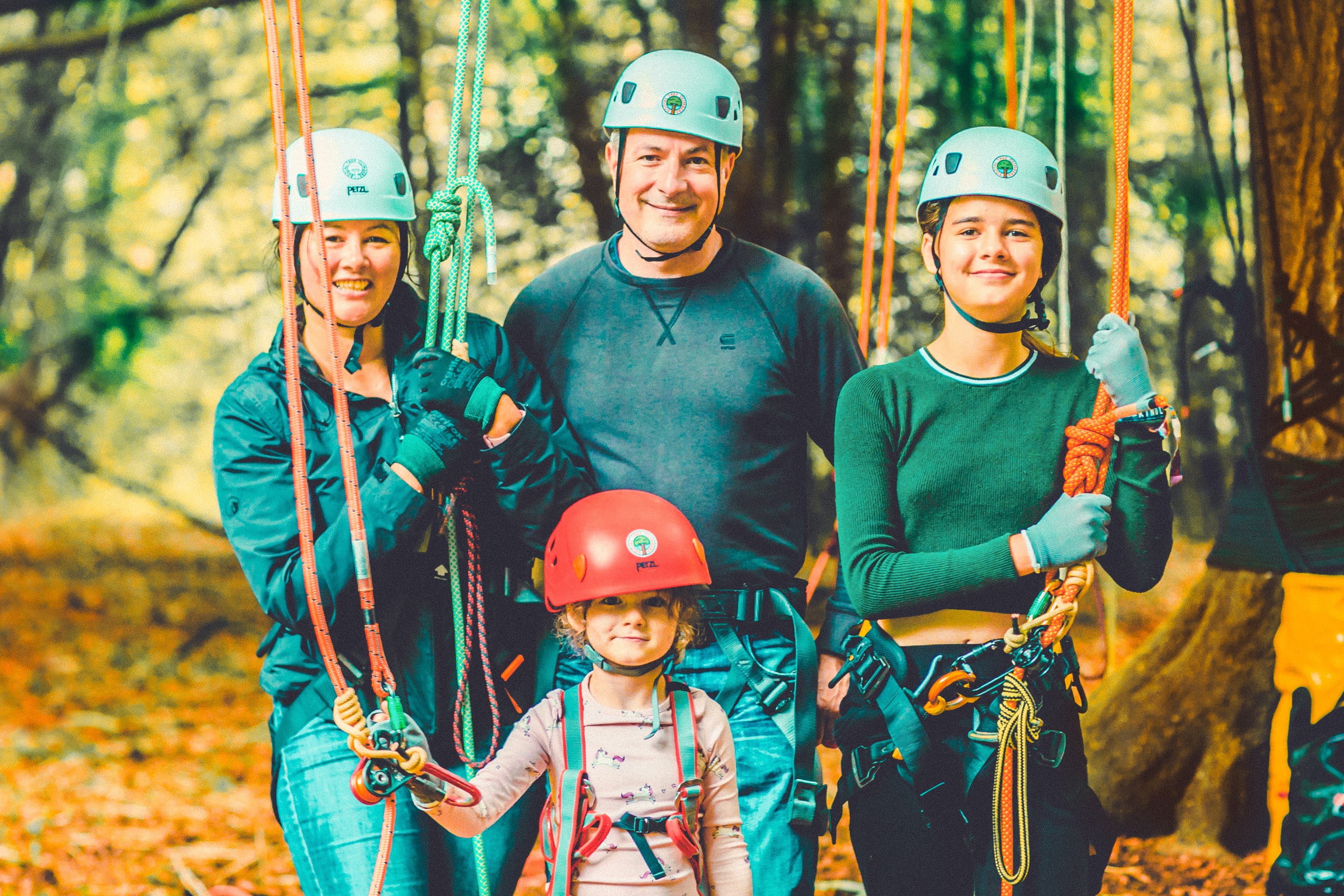 Family in tree climbing harnesses